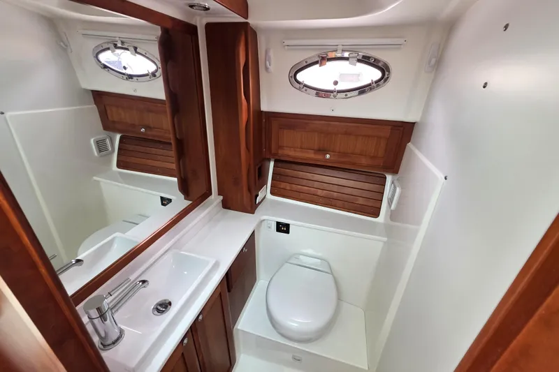 Jubilee Yacht Photos Pics Luxurious bathroom in 2018 Back Cove 32 yacht with wood accents and modern fixtures.