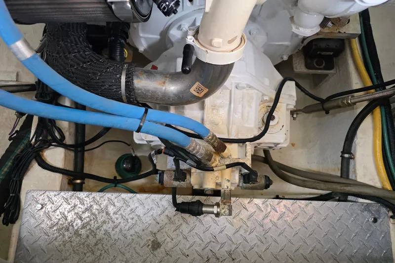 Jubilee Yacht Photos Pics Engine compartment of a 2018 Back Cove 32 boat with visible hoses and components.