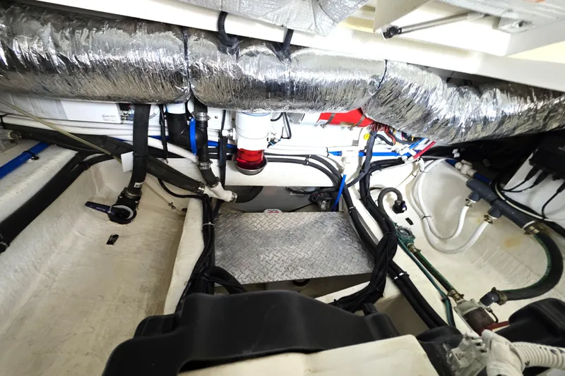Jubilee Yacht Photos Pics Engine compartment of a 2018 Back Cove 32 boat, featuring various hoses and components.