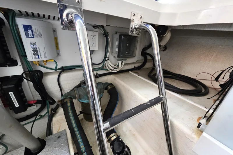 Jubilee Yacht Photos Pics Engine compartment of a 2018 Back Cove 32 boat, featuring wiring and a metal ladder.