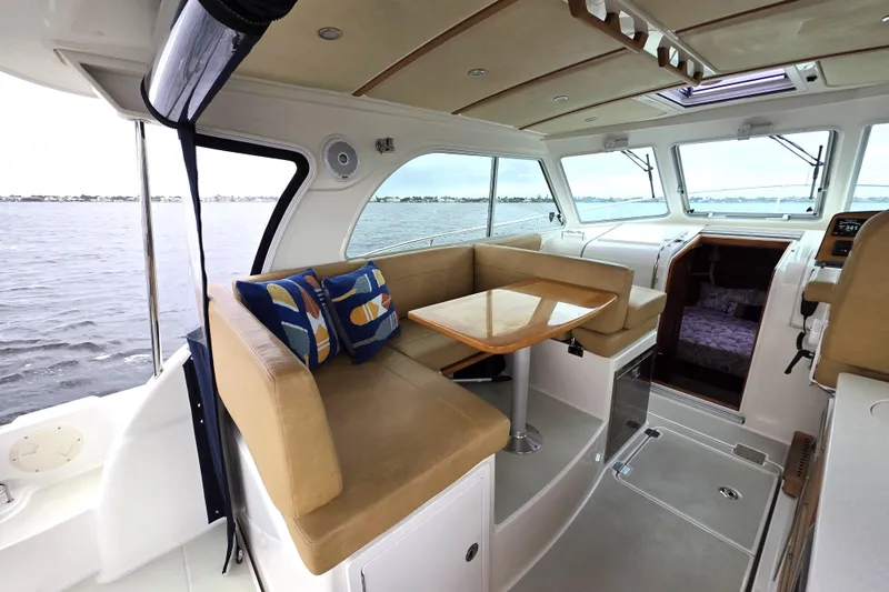 Jubilee Yacht Photos Pics Interior of 2018 Back Cove 32 yacht with seating and table, overlooking water.
