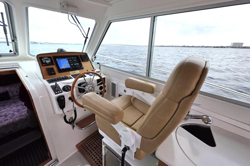 Jubilee Yacht Photos Pics 2018 Back Cove 32 boat interior with helm station and navigation equipment.