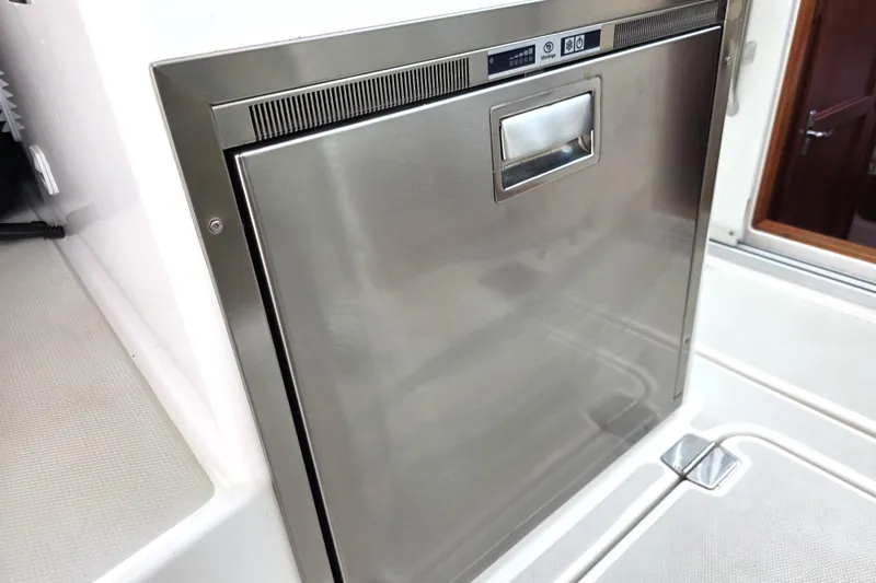 Jubilee Yacht Photos Pics Stainless steel refrigerator on 2018 Back Cove 32 yacht, featuring sleek design and modern controls.