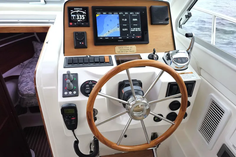 Jubilee Yacht Photos Pics Helm of 2018 Back Cove 32 boat with navigation equipment and wooden steering wheel.