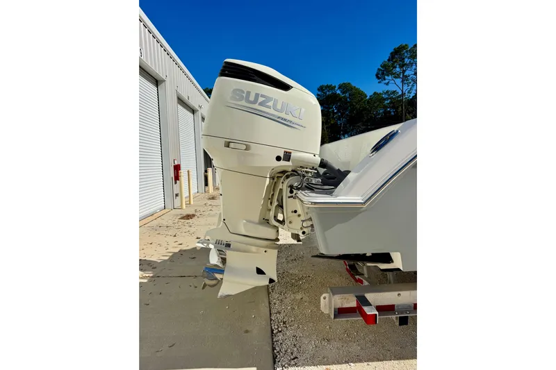  Yacht Photos Pics 2014 Invincible 36 Open Fisherman with Suzuki outboard motor, parked near storage facility.