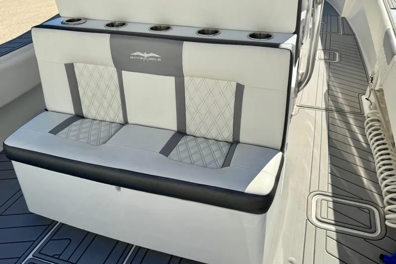  Yacht Photos Pics 2014 Invincible 36 Open Fisherman boat seating with cup holders and diamond-pattern upholstery.