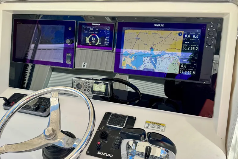  Yacht Photos Pics Control panel of 2014 Invincible 36 Open Fisherman with navigation screens and steering wheel.