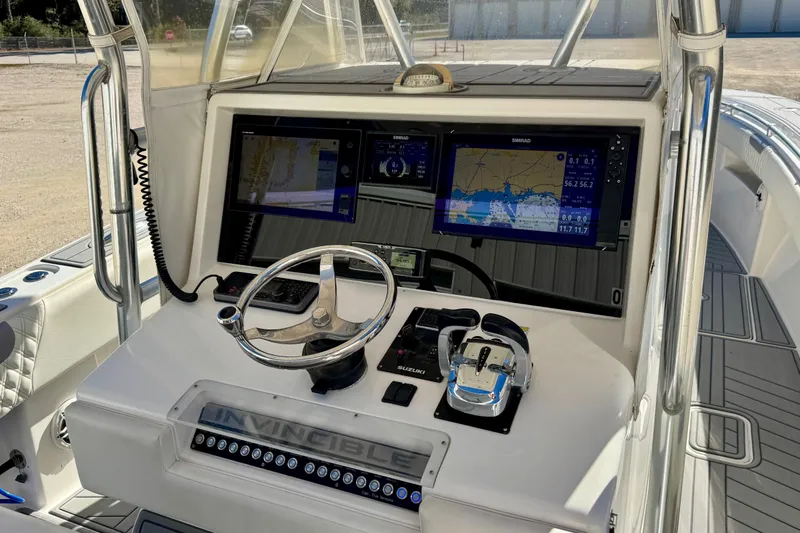  Yacht Photos Pics Control panel of 2014 Invincible 36 Open Fisherman with navigation screens and steering wheel.