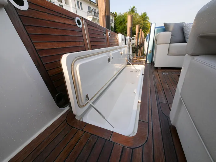 Low Hours Yacht Photos Pics 2020 Ocean Alexander 45 Divergence Sport boat with open storage compartment on teak deck.