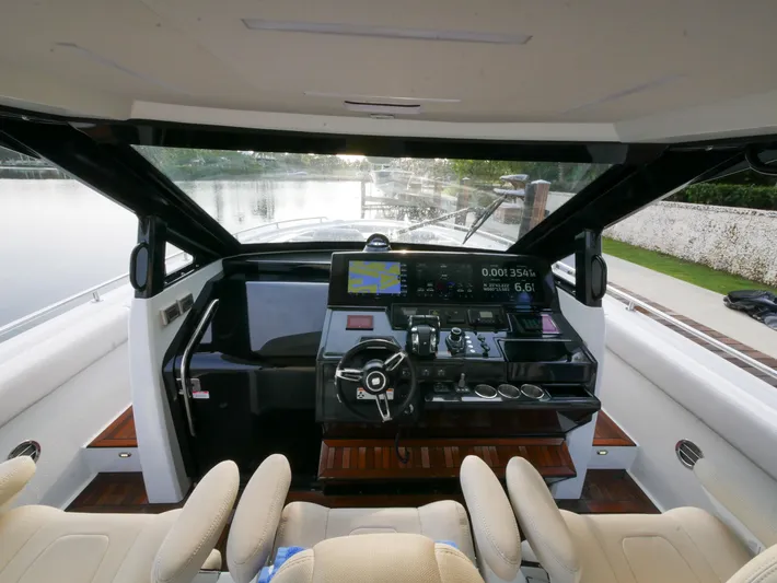 Low Hours Yacht Photos Pics 2020 Ocean Alexander 45 Divergence Sport helm with modern controls and scenic waterway view.