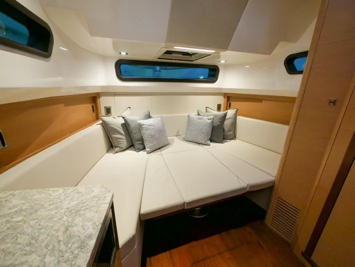 Low Hours Yacht Photos Pics Luxurious interior of 2020 Ocean Alexander 45 Divergence Sport yacht with plush seating and cushions.