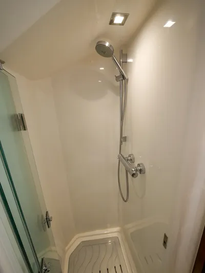 Low Hours Yacht Photos Pics Shower area in 2020 Ocean Alexander 45 Divergence Sport yacht, featuring modern fixtures.