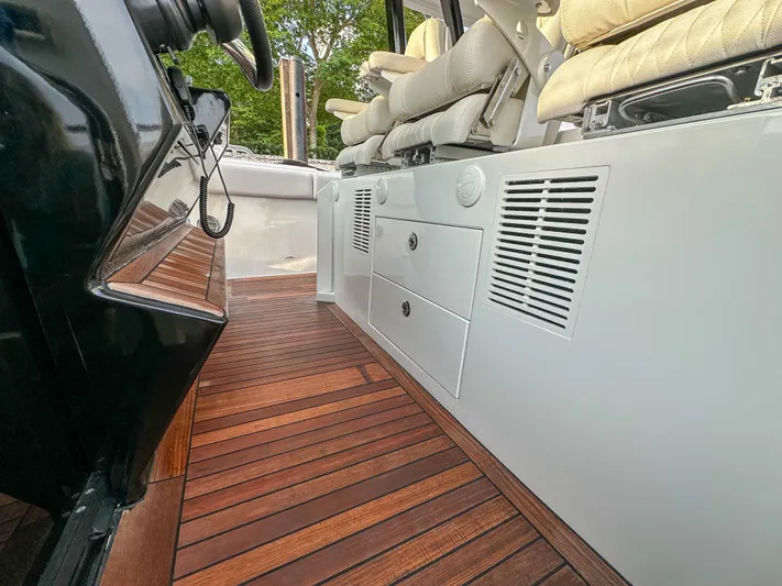 Low Hours Yacht Photos Pics 2020 Ocean Alexander 45 Divergence Sport interior with wooden flooring and cushioned seating.