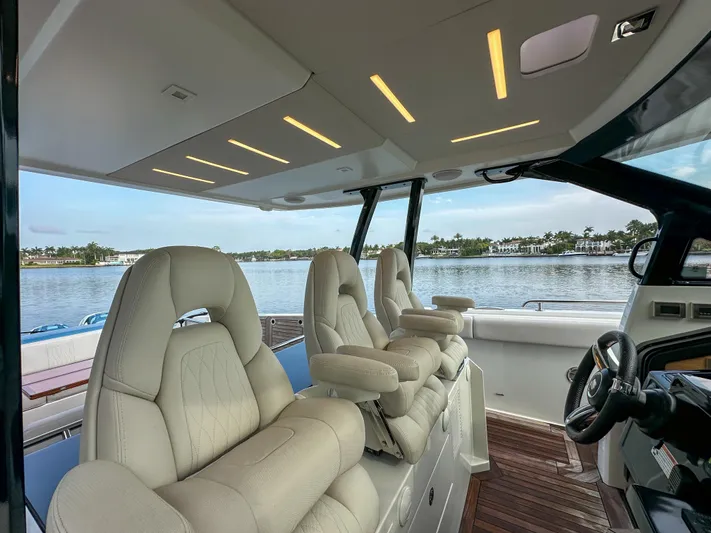 Low Hours Yacht Photos Pics Interior of 2020 Ocean Alexander 45 Divergence Sport yacht with luxurious seating and scenic water view.