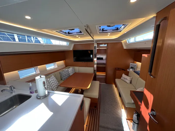 Better Together !! Yacht Photos Pics Modern interior of 2021 Bavaria C45 yacht with spacious seating and dining area.