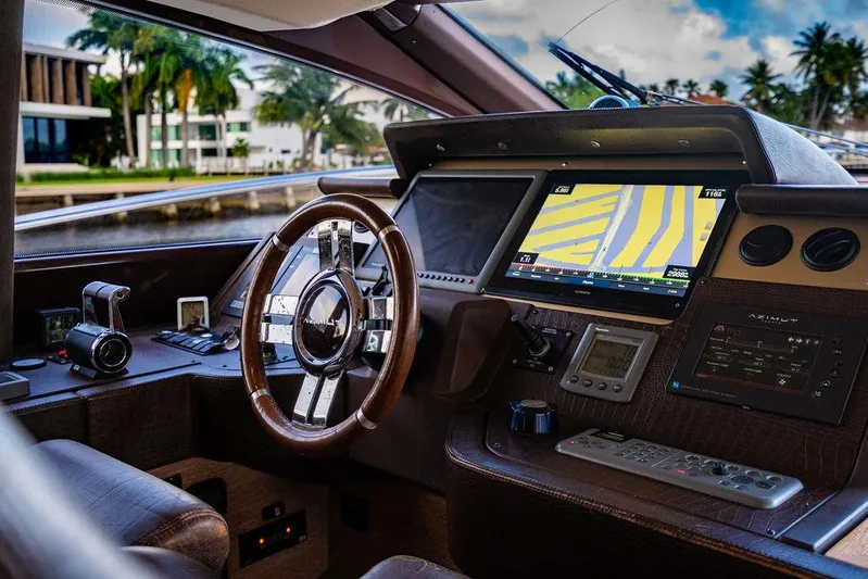 Vitamin Sea Yacht Photos Pics Cockpit of 2011 Azimut 70 Fly yacht with navigation system and steering wheel.
