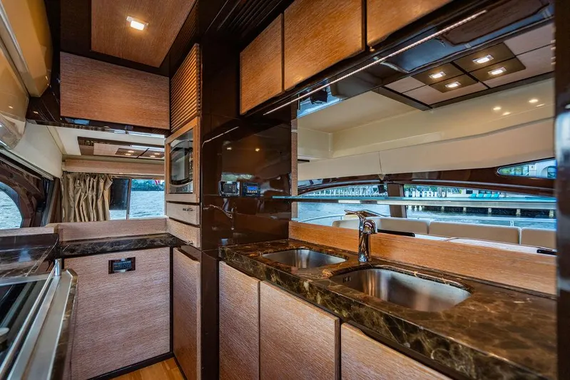 Vitamin Sea Yacht Photos Pics Luxurious kitchen interior of 2011 Azimut 70 Fly yacht with modern amenities and sleek design.