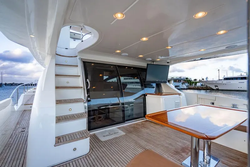 Vitamin Sea Yacht Photos Pics Luxurious 2011 Azimut 70 Fly yacht deck with seating, table, and staircase.