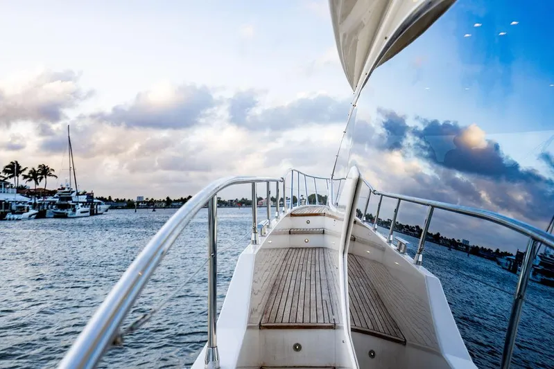 Vitamin Sea Yacht Photos Pics Azimut 70 Fly 2011 yacht on water, reflecting sky and clouds.