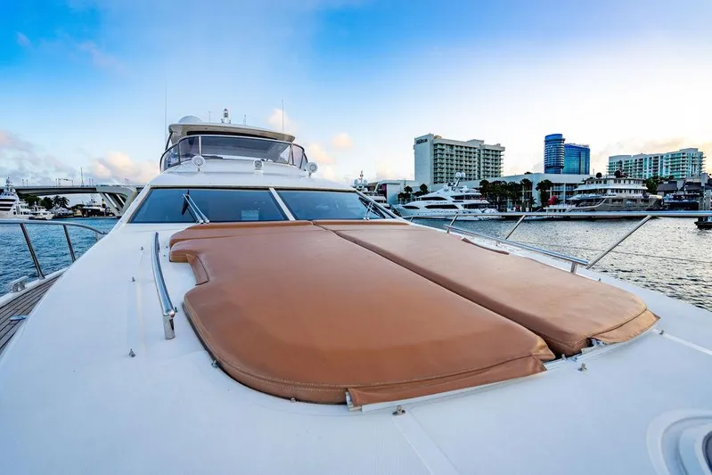 Vitamin Sea Yacht Photos Pics Azimut 70 Fly 2011 yacht with sunpads, docked near city skyline.