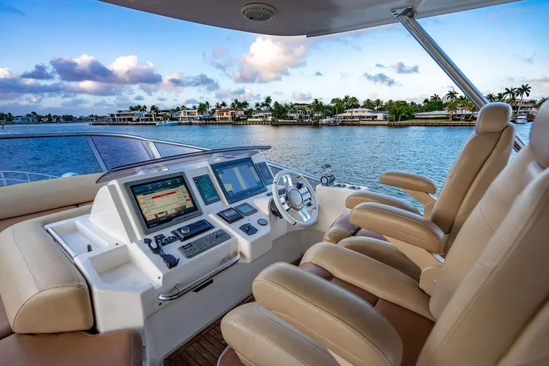 Vitamin Sea Yacht Photos Pics Luxurious helm of 2011 Azimut 70 Fly yacht with scenic waterfront view.