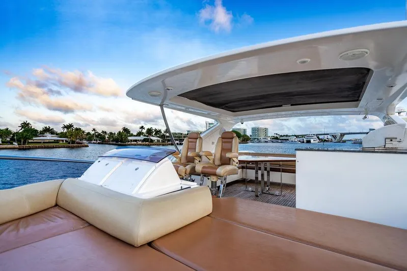 Vitamin Sea Yacht Photos Pics Luxurious 2011 Azimut 70 Fly yacht deck with seating, overlooking serene waterfront views.