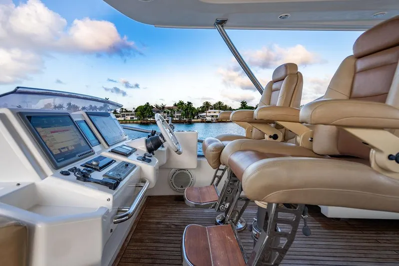 Vitamin Sea Yacht Photos Pics Luxury helm of 2011 Azimut 70 Fly yacht with leather seats and navigation controls.