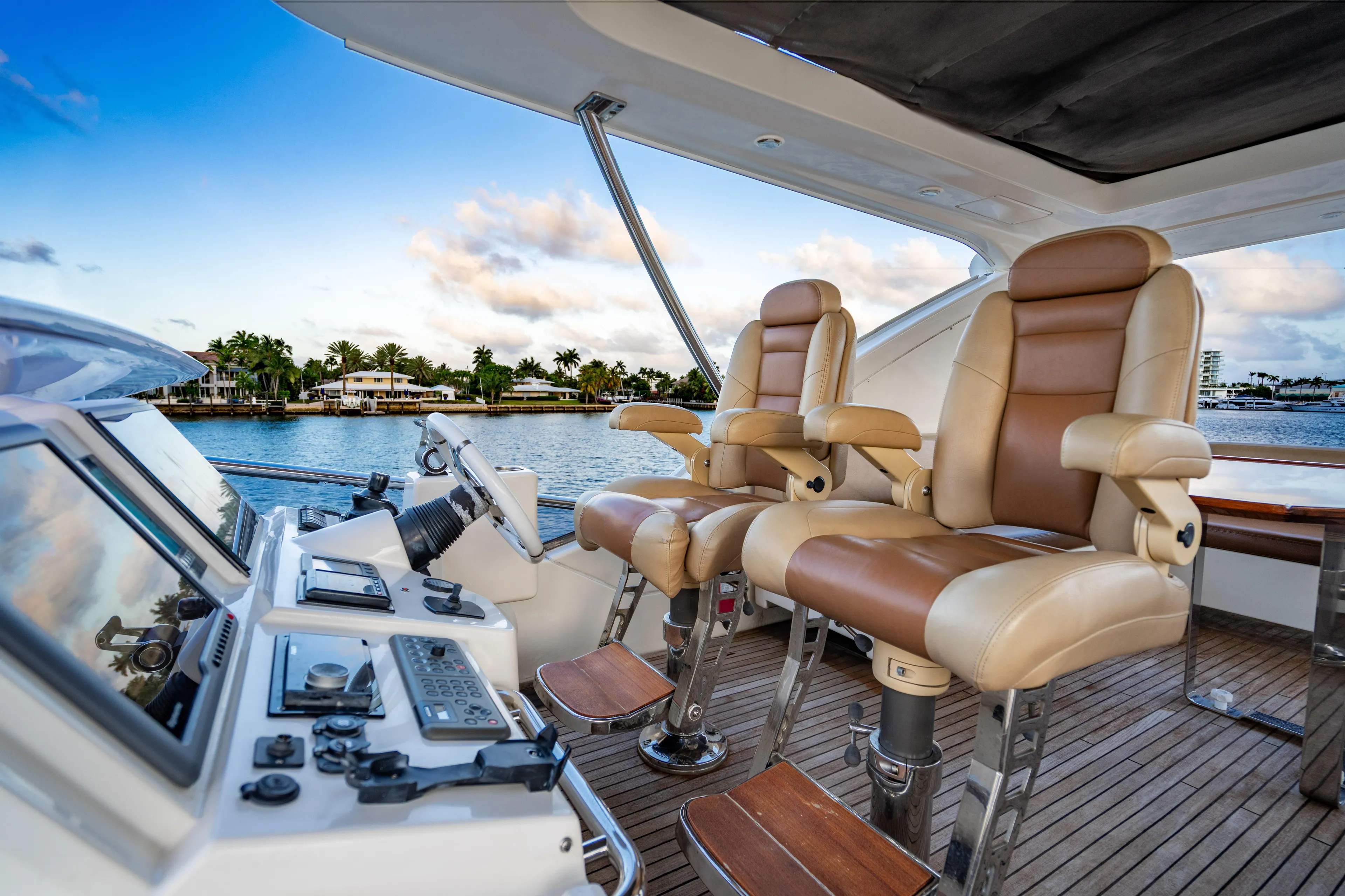 Vitamin Sea Yacht Photos Pics Luxurious helm of 2011 Azimut 70 Fly yacht with leather seats and control panel.