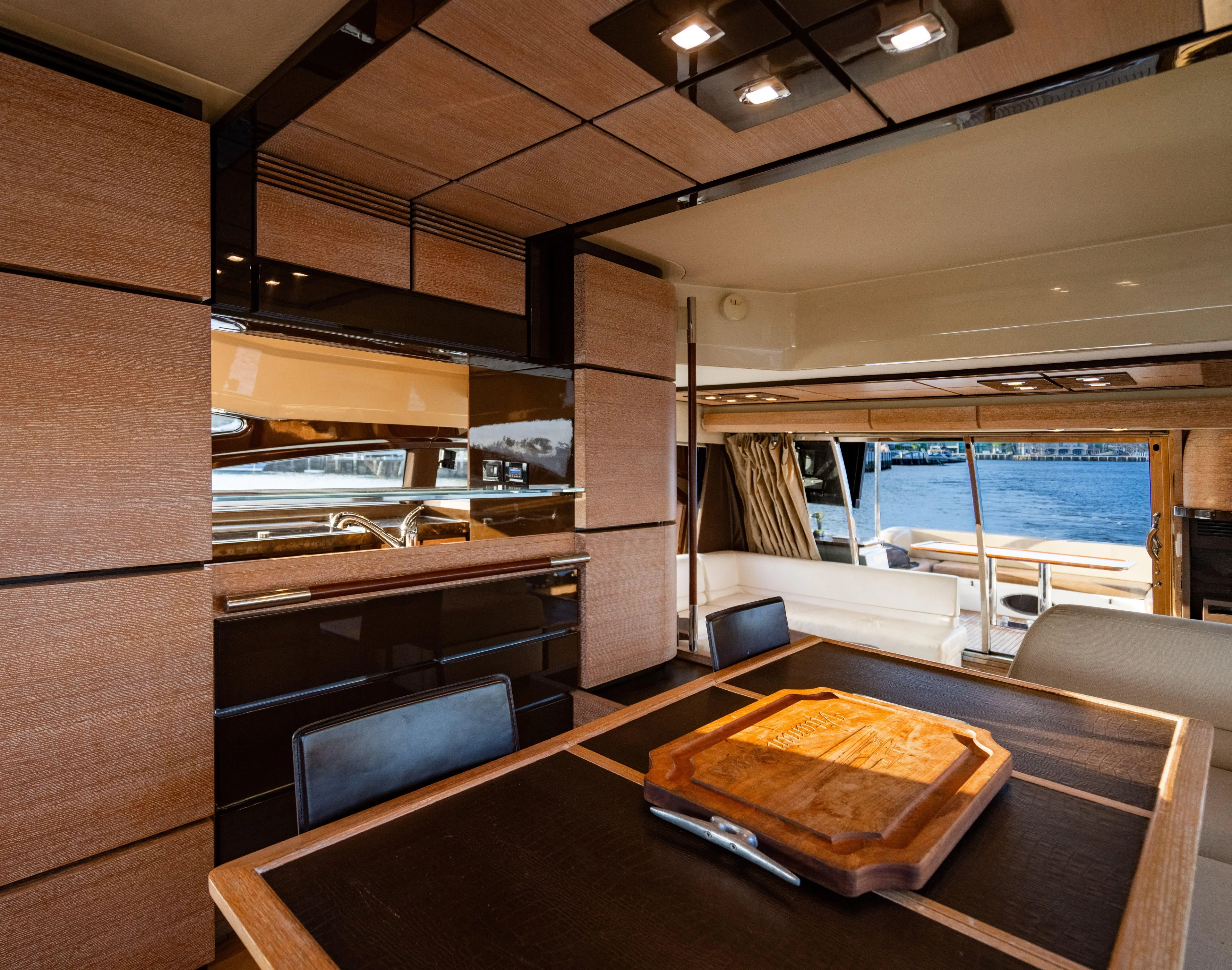 Vitamin Sea Yacht Photos Pics Luxurious interior of 2011 Azimut 70 Fly yacht with elegant wood finishes and dining area.