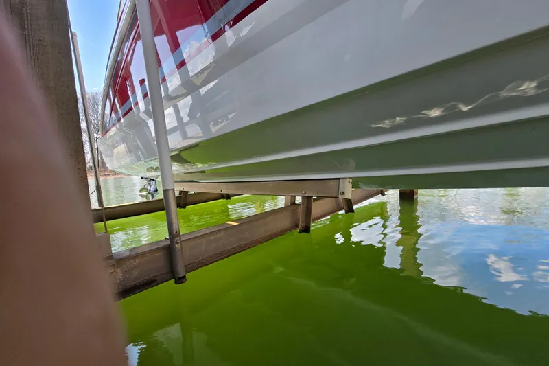  Yacht Photos Pics 2017 Formula 310 Sun Sport boat on lift above green water.