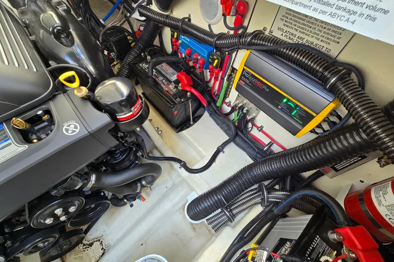  Yacht Photos Pics Engine compartment of a 2017 Formula 310 Sun Sport boat, featuring battery and wiring systems.