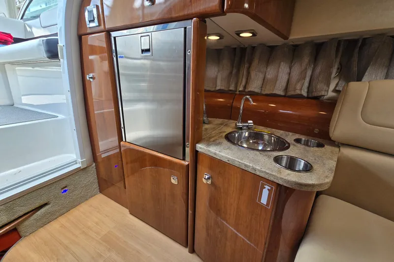  Yacht Photos Pics 2017 Formula 310 Sun Sport interior with kitchenette, featuring sink and stainless steel fridge.