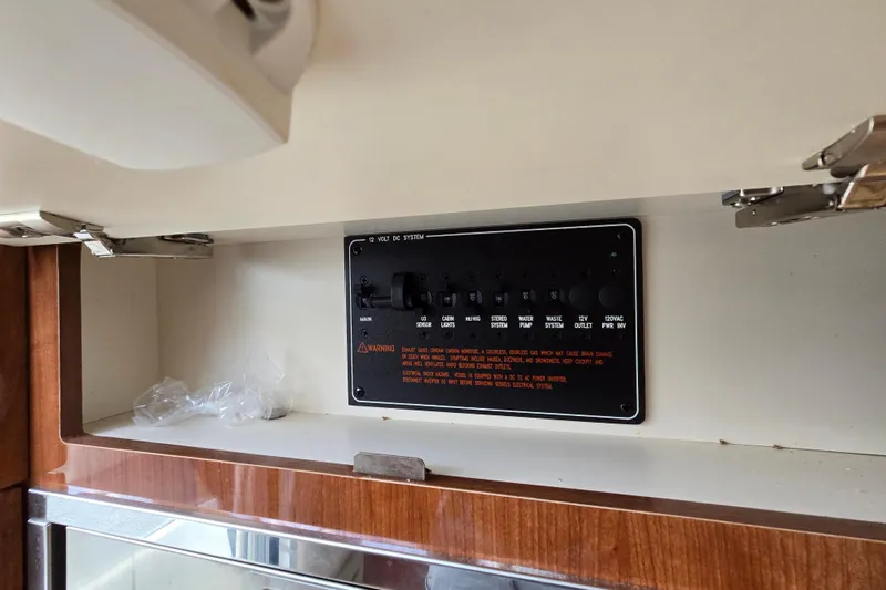  Yacht Photos Pics Control panel inside a 2017 Formula 310 Sun Sport boat, featuring various switches and warnings.