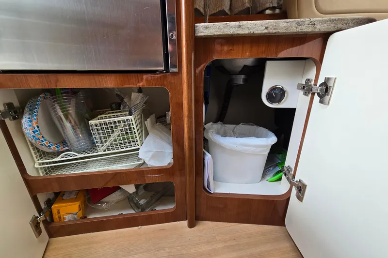  Yacht Photos Pics 2017 Formula 310 Sun Sport interior cabinets with storage and trash bin.