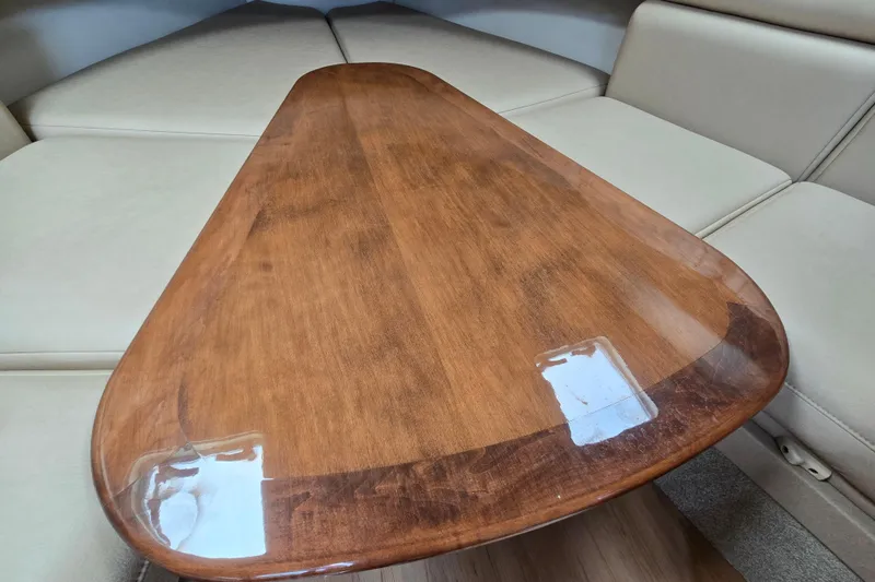  Yacht Photos Pics 2017 Formula 310 Sun Sport cabin with wooden table and beige seating.