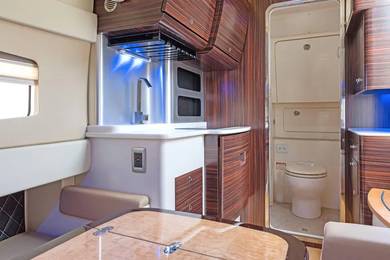  Yacht Photos Pics Luxurious interior of 2018 Scout 420 LXF yacht featuring kitchenette and bathroom.