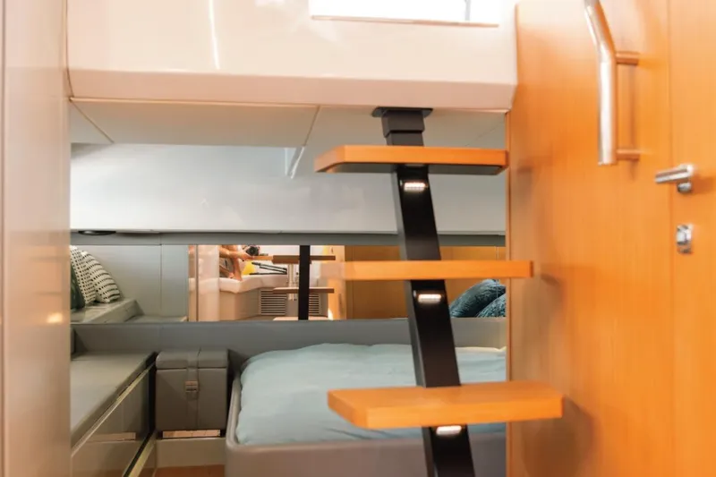  Yacht Photos Pics Interior of 2019 Bluegame BG42 yacht with modern wooden stairs and cozy cabin.