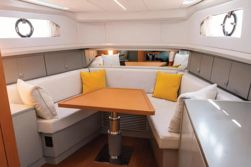  Yacht Photos Pics Luxurious interior of 2019 Bluegame BG42 yacht with cozy seating and vibrant cushions.