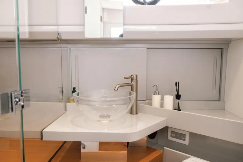  Yacht Photos Pics Modern bathroom interior of 2019 Bluegame BG42 yacht with glass sink and sleek fixtures.
