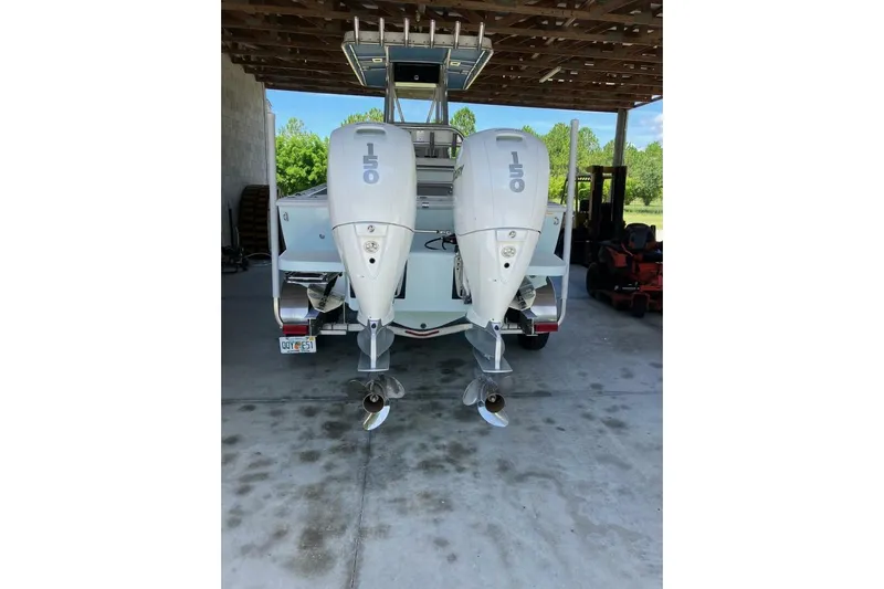  Yacht Photos Pics 2024 Latitude Tournament Boats 25 with dual 150 horsepower engines in a covered area.