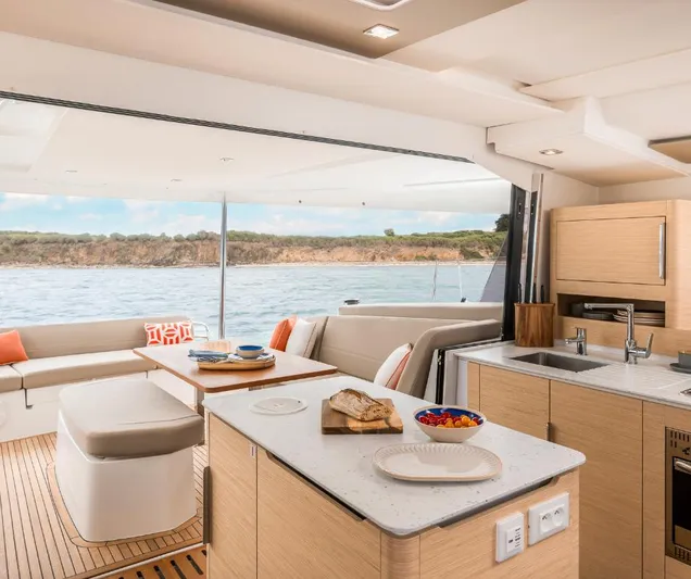 Fp41 In San Diego. Yacht Photos Pics Luxurious interior of 2025 Fountaine Pajot NEW 41 catamaran with modern kitchen and seating area.