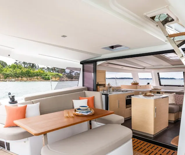 Fp41 In San Diego. Yacht Photos Pics Luxurious interior of 2025 Fountaine Pajot NEW 41 catamaran with modern kitchen and dining area.