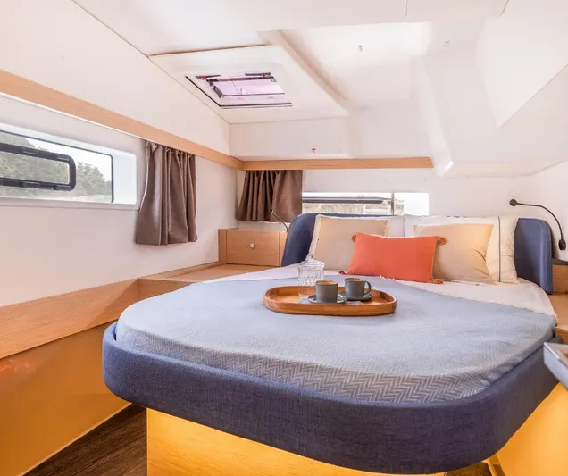 Fp41 In San Diego. Yacht Photos Pics Luxurious cabin interior of 2025 Fountaine Pajot NEW 41 catamaran, featuring cozy bedding and modern design.