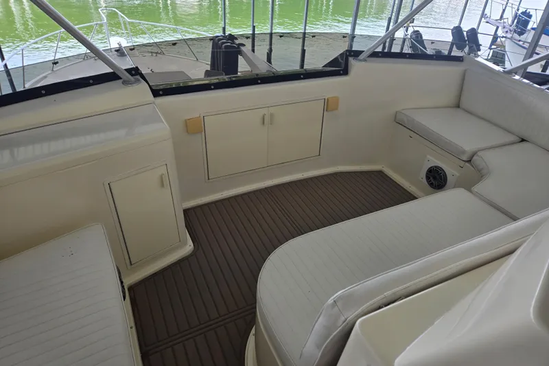 Lay A Wake Yacht Photos Pics 1990 Viking 53 Convertible yacht interior with white seating and storage cabinets.