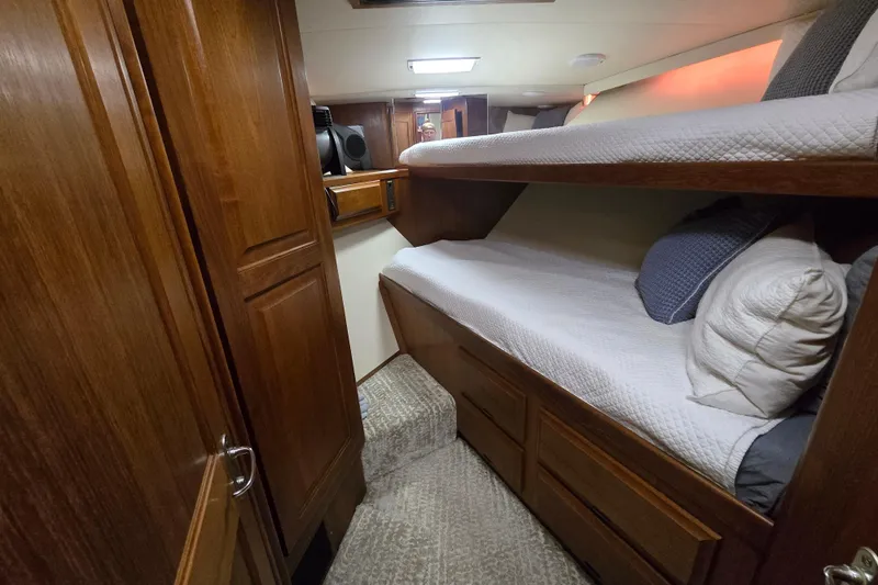 Lay A Wake Yacht Photos Pics Cozy cabin interior of 1990 Viking 53 Convertible yacht with wooden bunk beds.