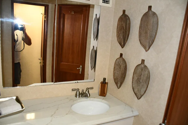 Lay A Wake Yacht Photos Pics Bathroom interior of 1990 Viking 53 Convertible with decorative leaf wall art.