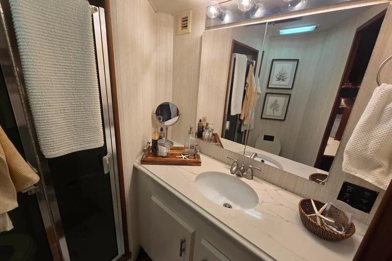 Lay A Wake Yacht Photos Pics Bathroom interior of 1990 Viking 53 Convertible yacht with modern fixtures and decor.