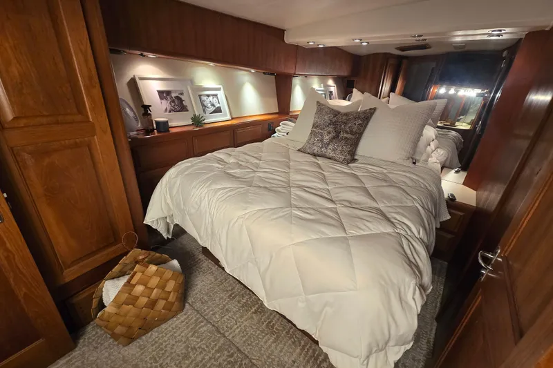 Lay A Wake Yacht Photos Pics Luxurious bedroom interior of 1990 Viking 53 Convertible yacht with cozy bedding and wooden cabinetry.