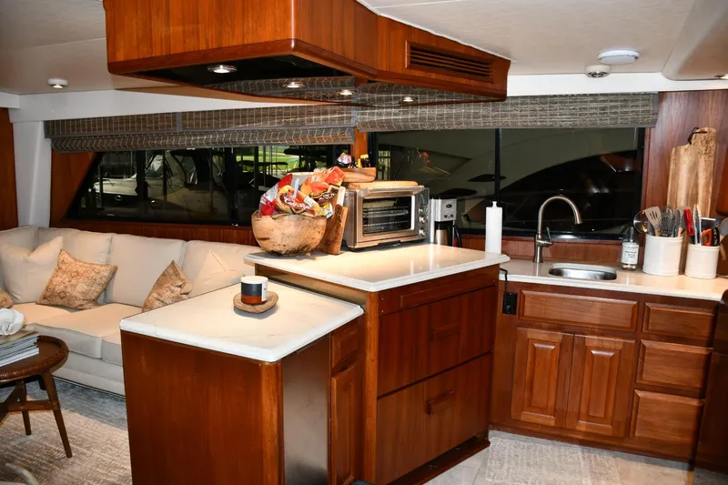 Lay A Wake Yacht Photos Pics Interior of 1990 Viking 53 Convertible yacht with modern kitchen and cozy seating area.