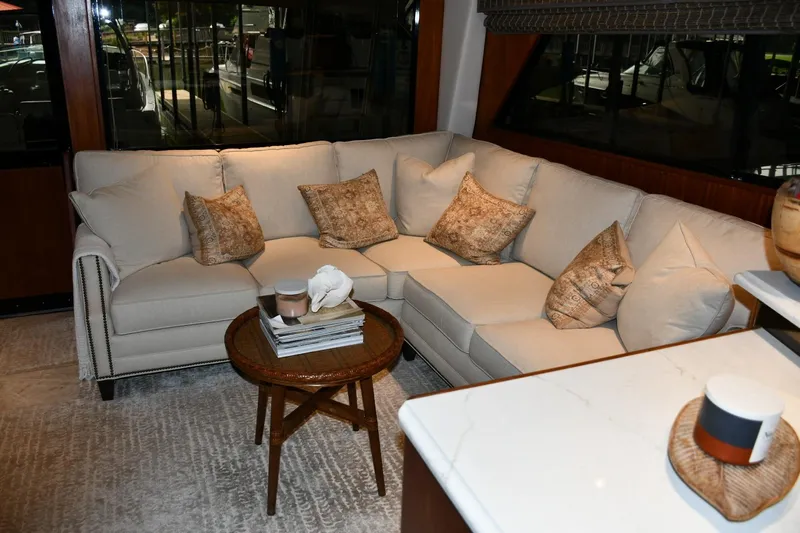 Lay A Wake Yacht Photos Pics Luxurious interior of 1990 Viking 53 Convertible yacht with elegant beige sofa and cushions.